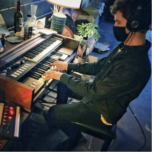 Person playing electric organ.